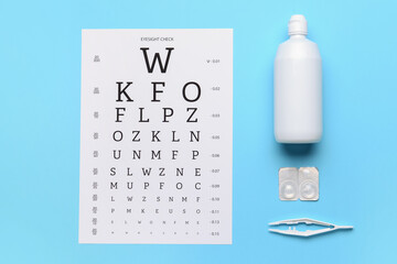 Contact lenses, tweezers, solution and eye test chart on color background