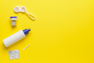 Containers with contact lenses, solutions and tweezers on color background