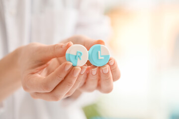 Woman holding contact lens case in clinic