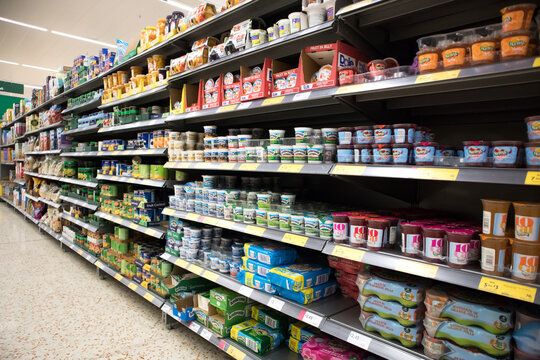 Supermarket display of packaged food groceries on shelves for purchase