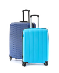 Packed suitcases on white background