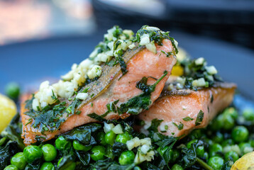 Salmon fillet with green peas and spinach