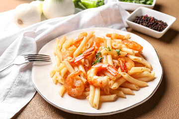 Plate of tasty pasta with shrimps on table