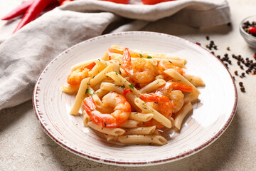 Plate of tasty pasta with shrimps on table