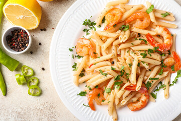 Plate of tasty pasta with shrimps on table