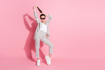 Full length photo of young beautiful woman plump lips hands touch hair isolated over pink color background