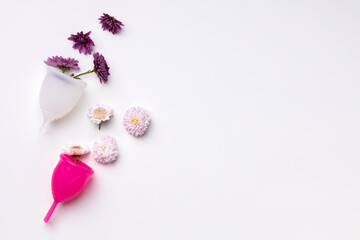 Menstrual cup with flowers on white background