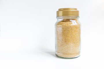 Brown sugar in clear glass bottle on white background, organic dark brown sugar, 
