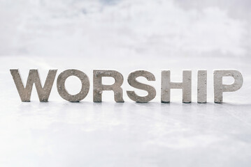 Word Worship made with cement letters on grey marble background. Copy space. Biblical, spiritual or christian reminder. Good friday, Easter day in church. Christian music concert, Sunday service