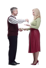 smiling man handing keys to a young woman . isolated on a white