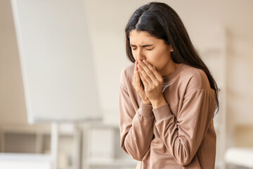Coughing young woman at home