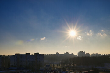 Fototapeta premium Photo of the sky with the sun. Morning city landscape.