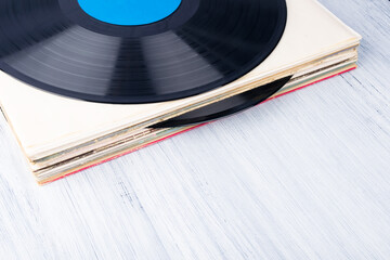 an old vinyl record lies on a light gray table, top view