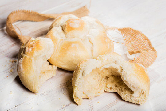 michetta bread over white wooden table