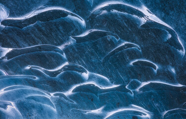 Crystal clear blue ice patterns in a swiss ice cave, Switzerland