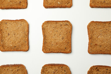 Flat lay with dark bread slices on white background
