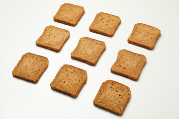 Flat lay with dark bread slices on white background