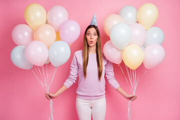 Portrait of pretty funny amazed straight-haired girl holding in hands air helium balls pout lips isolated over pink color background - obrazy, fototapety, plakaty