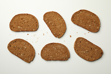 Rye bread slices on white background, top view