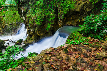 Small waterfall from mountain shows natural wonder that is part of Tao Thong Waterfall in Phang Nga, Thailand and gives a refreshing feel of a rainforest, shot with slow shutter speed and copyspace.