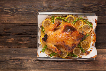 Chicken or duck baked in oven on festive dinner table, top view