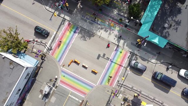 1-3 aerial twist panaramic birds eye view above Davie and Bute rainbow sidewalks in downtown Vancouver's Gay Village Coimmunity on a sunny afternoon with COVID-19 barriers on streets for safe walking