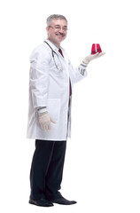 smiling doctor looking at the liquid in the flask