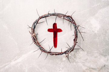 Crown of thorns, cross painted with red blood on stone background. Copy space. Good friday....