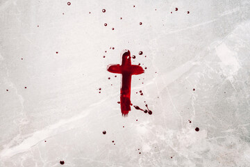 Crucifix made of blood. Good friday. Easter holiday. Christian cross painted with blood on stone background. Passion, crucifixion of Jesus Christ. Gospel, salvation concept