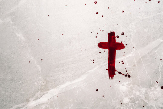 Christian cross painted with red blood on stone background. Copy space. Good friday. Passion, crucifixion of Jesus Christ. Christian Easter holiday. Crucifix, gospel, salvation concept