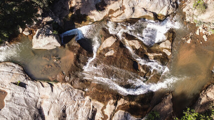 Waterfall in deep forest There are rocks and trees.