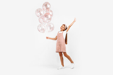 happy little kid, with many balloons in hand, over isolated white background
