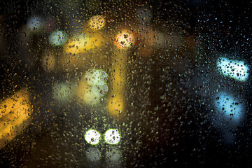Droplet water on glass background night in the city have bokeh.