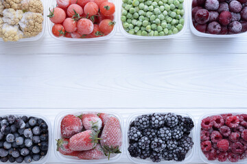Top view of frozen berries in boxes on white background with place for text