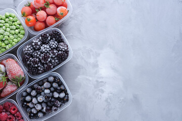 Top view variety of frozen berries in boxes with copy space