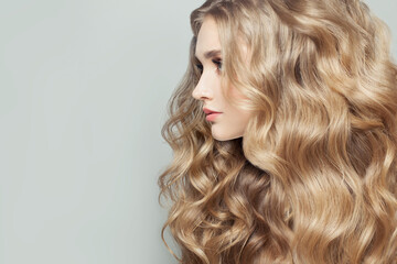 Beautiful woman with long healthy blonde curly hair, female face profile closeup