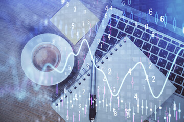 Double exposure of forex chart drawing over table background with computer. Concept of financial research and analysis. Top view.