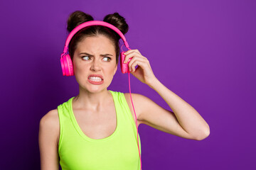 Naklejka premium Close-up portrait of pretty mad furious gloomy girl fan listening single chart funk bad song dislike isolated on bright violet color background