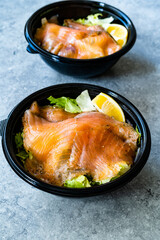 Take Away Salmon Gravlax Salad in Black Plastic Bowl Container and Mustard Sauce Package.