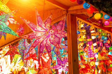 Paper bright multi-colored stars on christmas sale and New Year stars decorations.