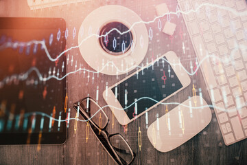 Multi exposure of forex graph hologram over desktop with phone. Top view. Mobile trade platform concept.