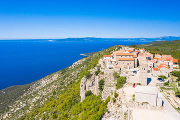 Naklejka na ściany i meble Aerial view of small town of Lubenice on the high cliff above the Adriatic sea, Cres island in Croatia