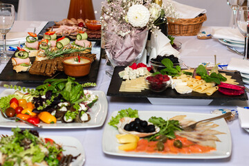 Table setting, food and decorations for important and family events, delicious snacks and hot dishes.