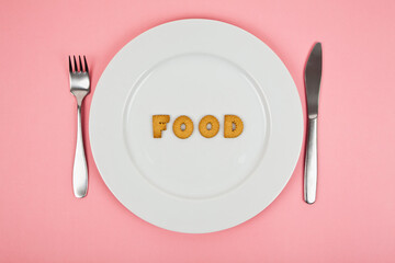 Letter cookies on a white plate forming the word 