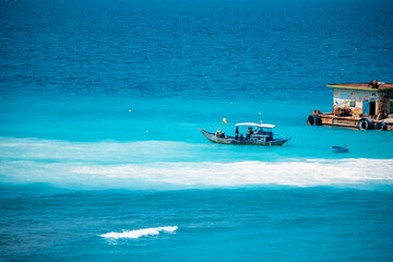 Fototapeta premium the boat on the blue sea