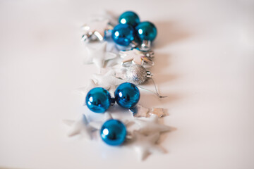 Christmas decoration on white background. Cozy silver blue christmas star and christmas ornaments.