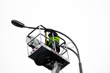 Electricians are repairing street lights. work service of street lighting.