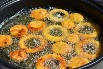 Pumpkin rings in deep fryer.