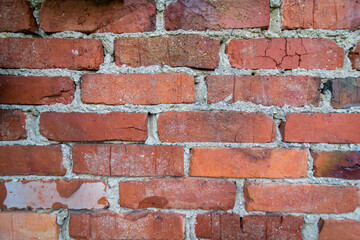 Obraz premium Old red wall made out of red bricks. Bricks are different hue form aging.