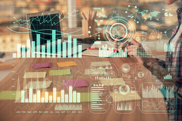 Double exposure of woman hands working on computer and forex graph hologram drawing. Financial analysis concept.